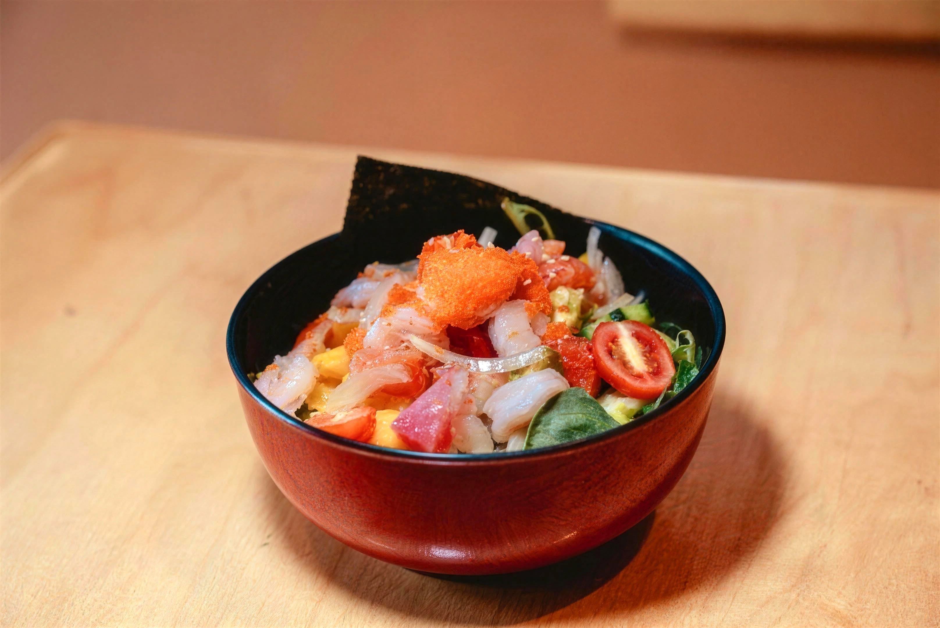 A poké bowl with shrimp, salmon, tobiko and cherry tomato at Luv Fish